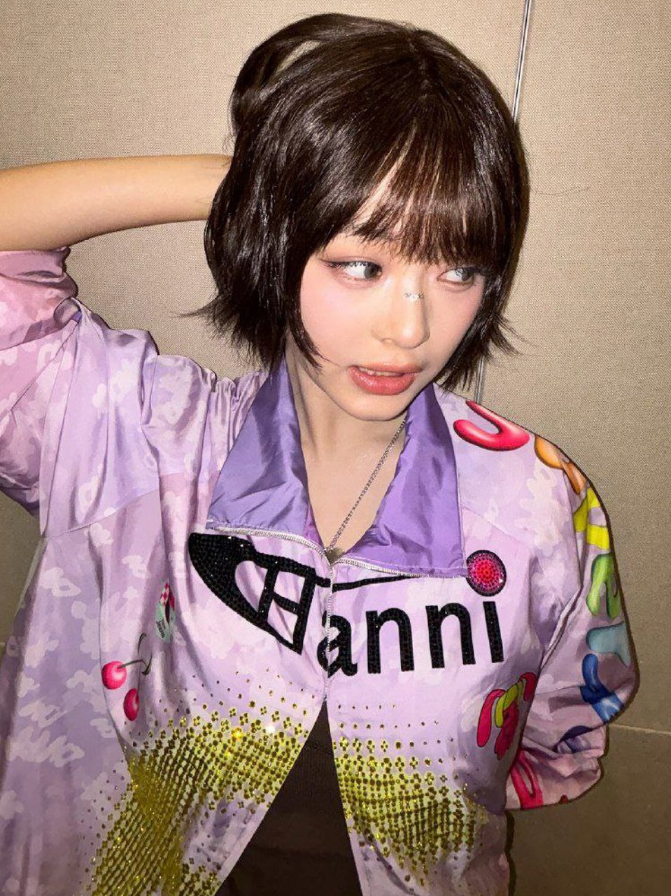 Hannea with short hair in a purple patterned outfit
