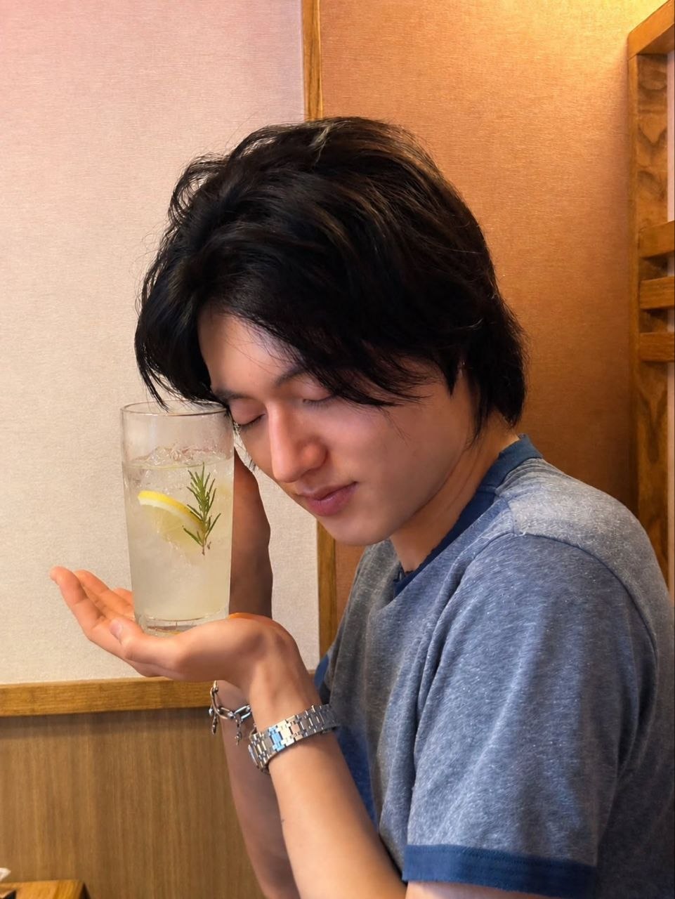 Harsha holding a glass with his eyes closed